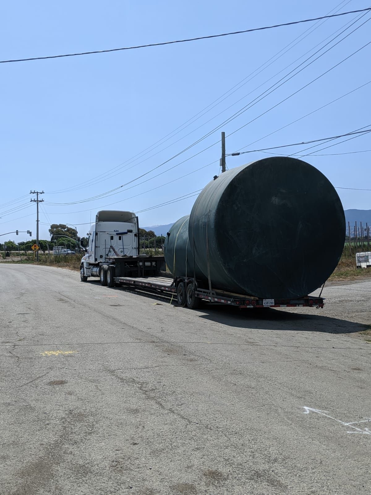 A water storage tank arriving on a flatbed truck