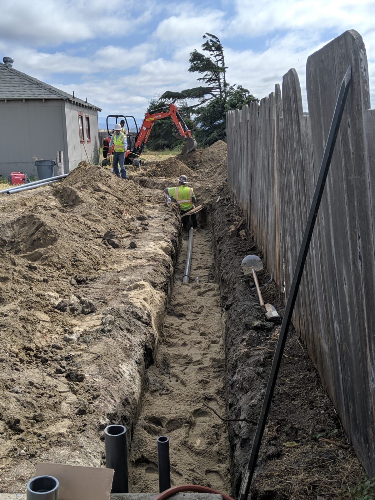 Crew digging a trench for the water line