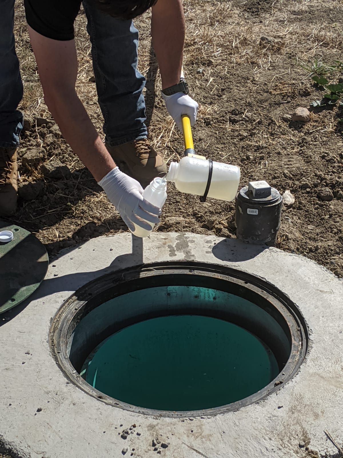 Taking a water sample at a well site